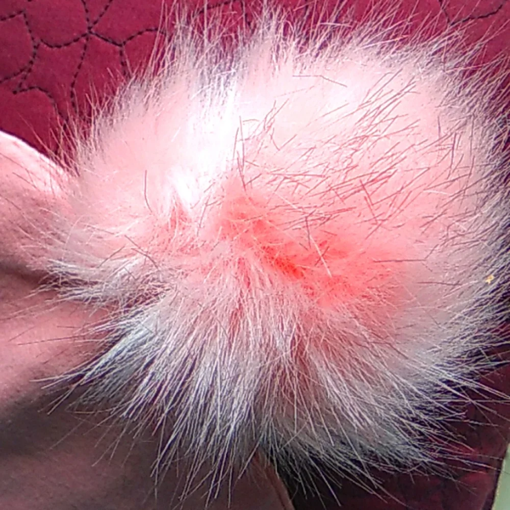 Pink hat with big fur pom pom